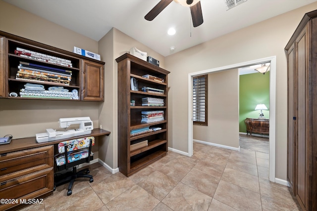 office with light tile patterned floors, built in desk, and ceiling fan