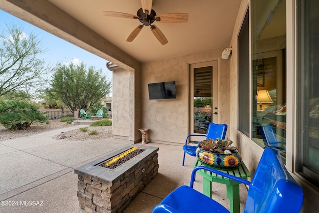 view of patio / terrace featuring ceiling fan and a fire pit