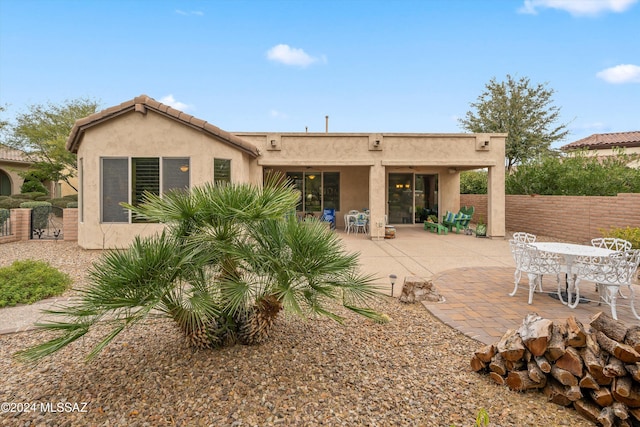 rear view of property featuring a patio area