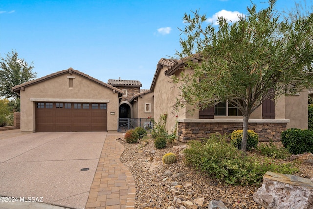 mediterranean / spanish house featuring a garage