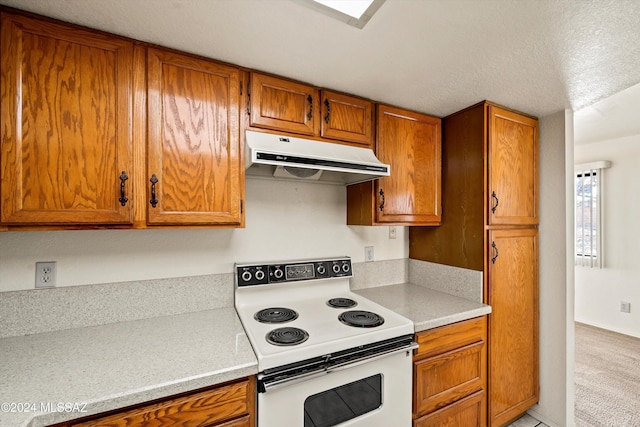 kitchen with a textured ceiling and white electric range