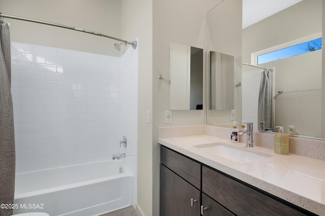 bathroom with shower / bath combo with shower curtain and vanity