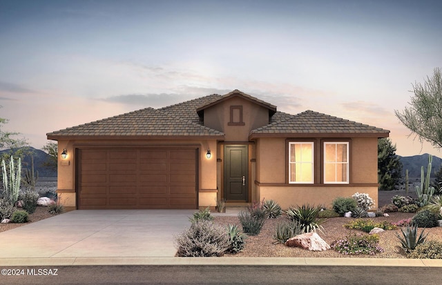 view of front of house with a mountain view and a garage