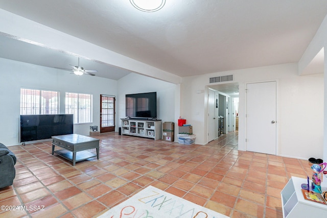 tiled living room featuring ceiling fan and lofted ceiling