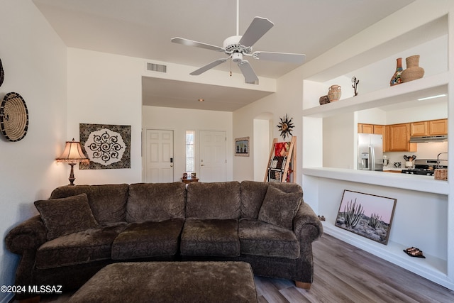 living room featuring hardwood / wood-style floors and ceiling fan