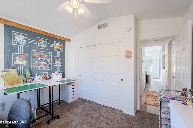 office featuring ceiling fan, dark carpet, and vaulted ceiling