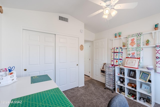 bedroom featuring ceiling fan, a closet, dark carpet, and lofted ceiling