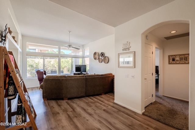 living room featuring wood-type flooring and ceiling fan