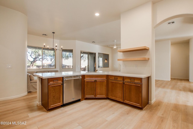 kitchen with pendant lighting, sink, stainless steel dishwasher, light hardwood / wood-style floors, and a chandelier