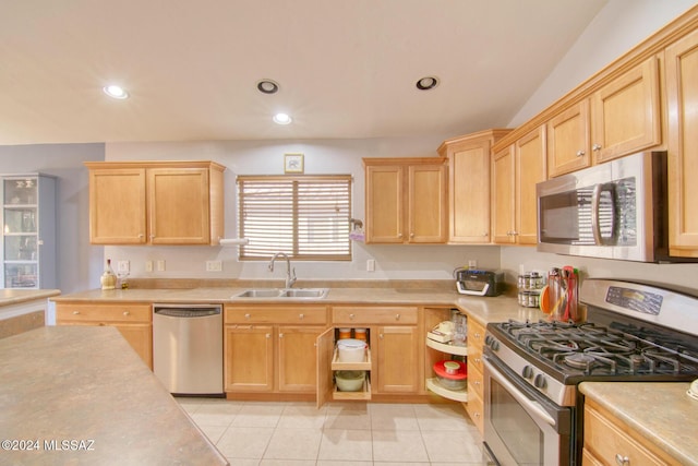 kitchen with light tile patterned flooring, appliances with stainless steel finishes, light brown cabinets, and sink