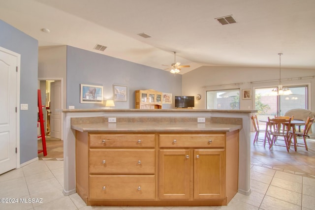 kitchen with pendant lighting, ceiling fan with notable chandelier, lofted ceiling, and light tile patterned floors