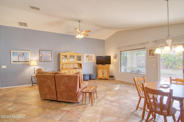 living room featuring ceiling fan with notable chandelier and vaulted ceiling