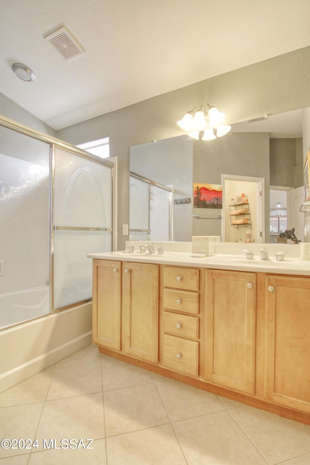 bathroom with tile patterned flooring, vanity, shower / bath combination with glass door, and a notable chandelier