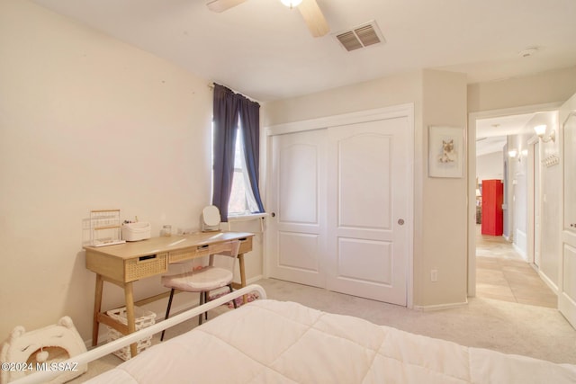 carpeted bedroom featuring a closet and ceiling fan