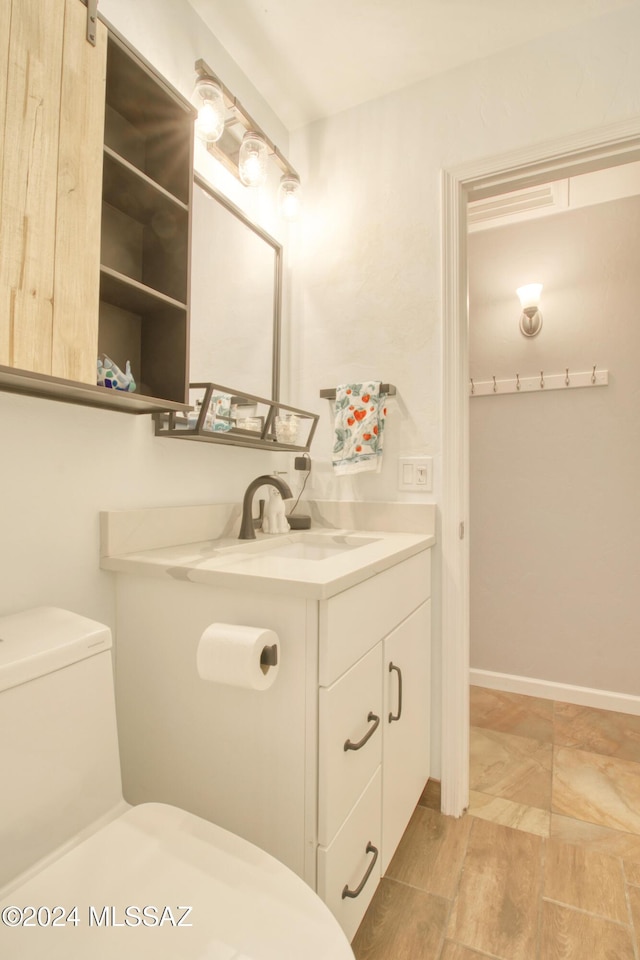 bathroom with vanity and toilet