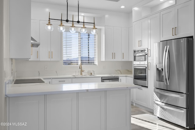 kitchen with white cabinetry, sink, hanging light fixtures, and appliances with stainless steel finishes