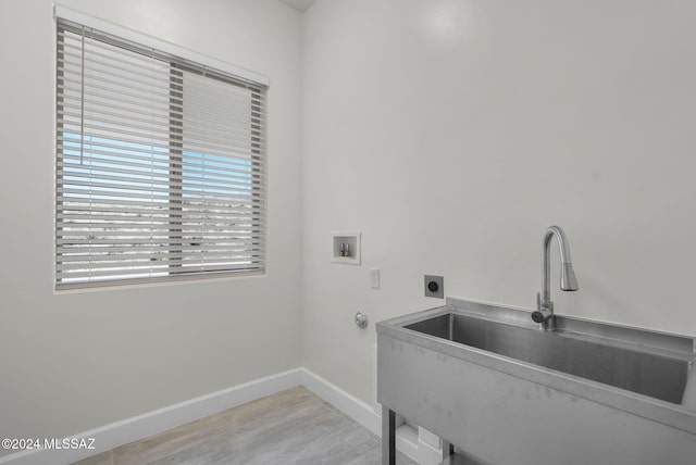 laundry area with hookup for a washing machine, sink, and hookup for an electric dryer