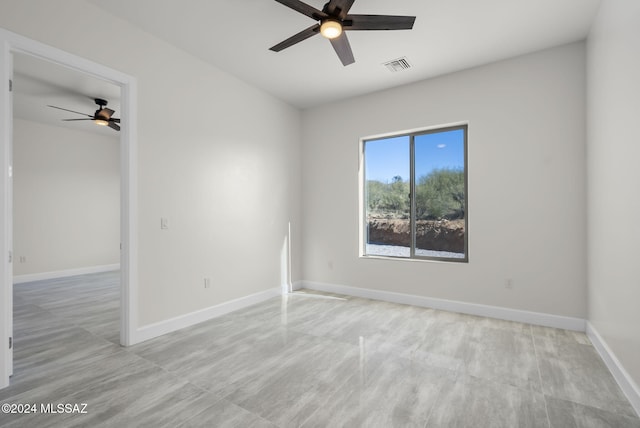 spare room with ceiling fan