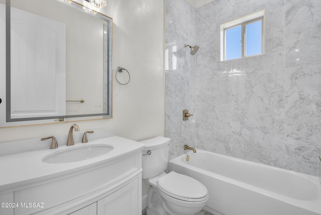 full bathroom featuring vanity, tiled shower / bath combo, and toilet