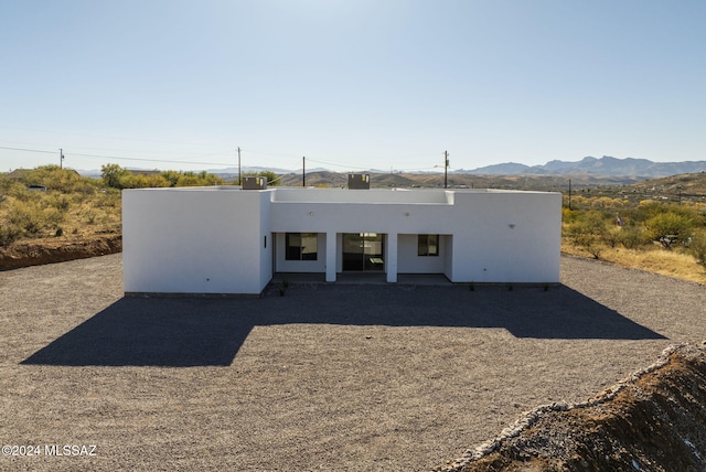 rear view of property with a mountain view and central air condition unit