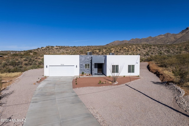 pueblo-style house with a mountain view and a garage