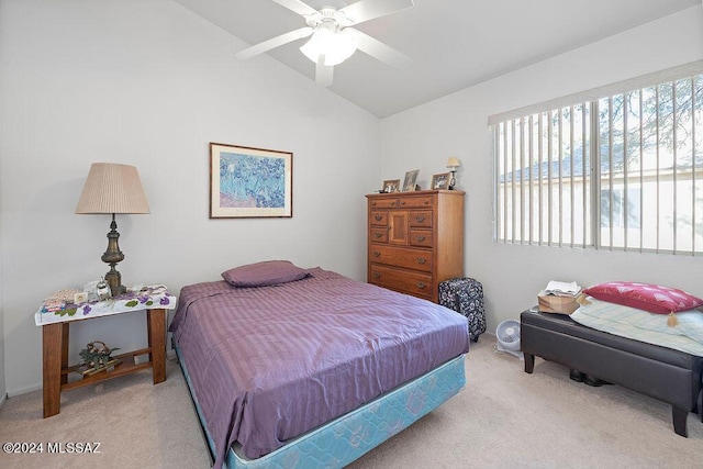 carpeted bedroom featuring ceiling fan and vaulted ceiling