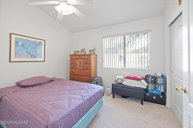 carpeted bedroom featuring a closet, vaulted ceiling, and ceiling fan