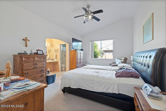 carpeted bedroom featuring ceiling fan, lofted ceiling, and connected bathroom