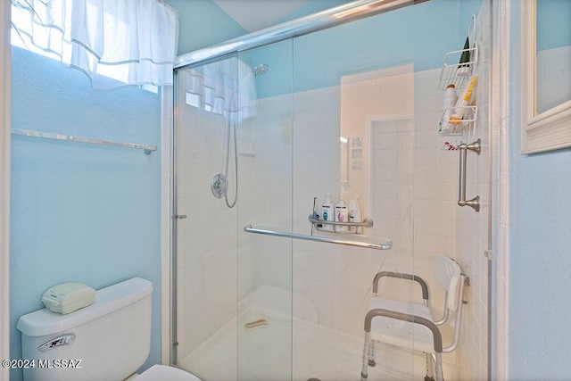 bathroom featuring an enclosed shower and toilet