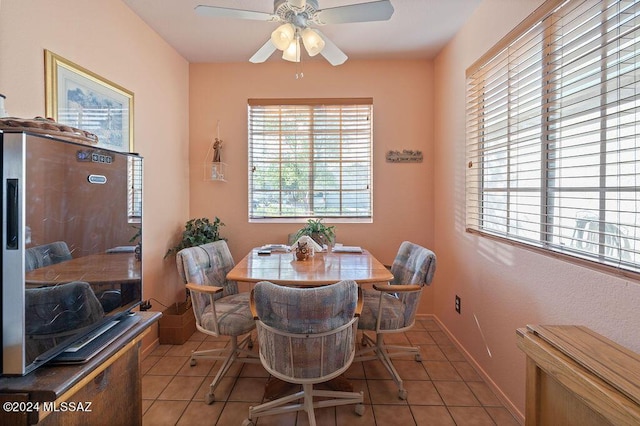 tiled dining space featuring ceiling fan