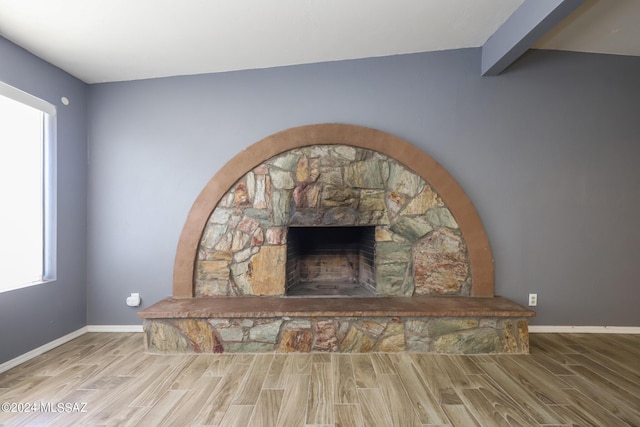 details featuring hardwood / wood-style flooring, a fireplace, and beamed ceiling