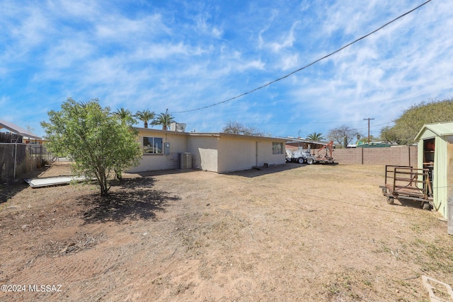 rear view of property with central air condition unit