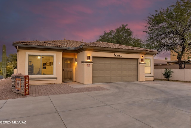 mediterranean / spanish house featuring a garage