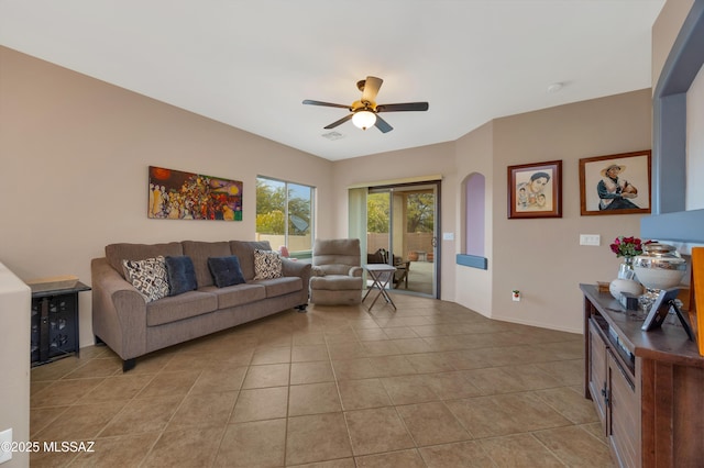 tiled living room featuring beverage cooler and ceiling fan