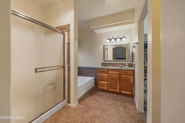 bathroom with tile patterned flooring, vanity, and separate shower and tub