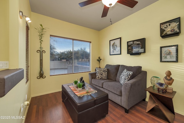 living room featuring dark wood-type flooring and ceiling fan