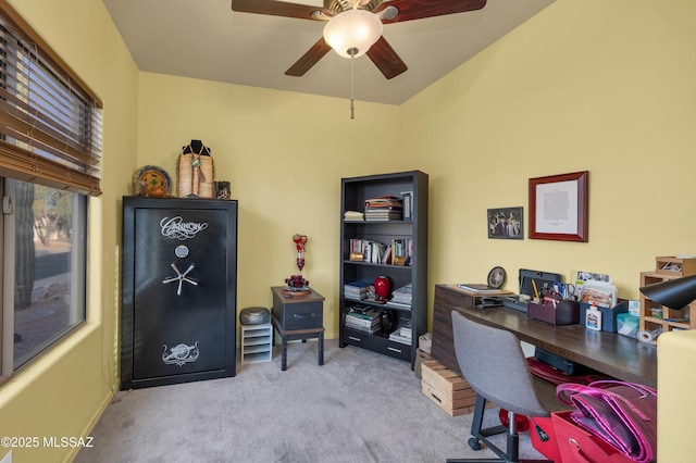 carpeted office space with ceiling fan