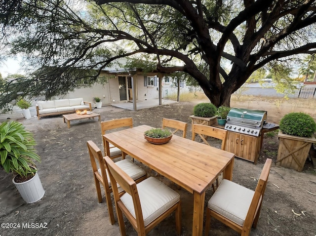 view of patio / terrace featuring area for grilling and an outdoor living space with a fire pit