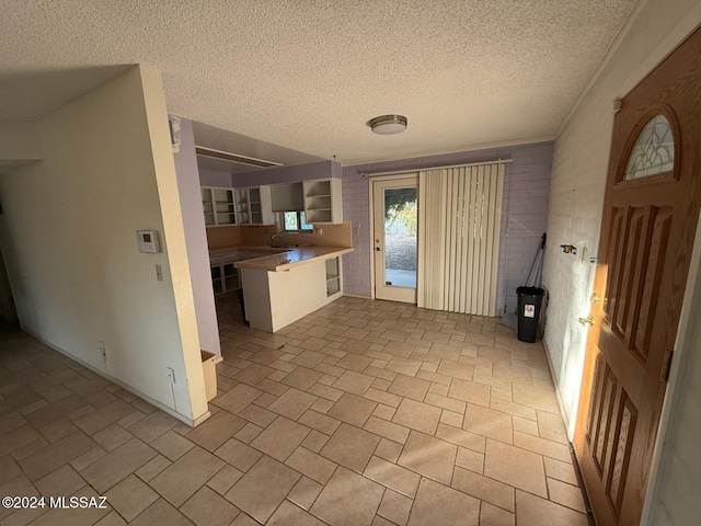 kitchen with a textured ceiling and sink