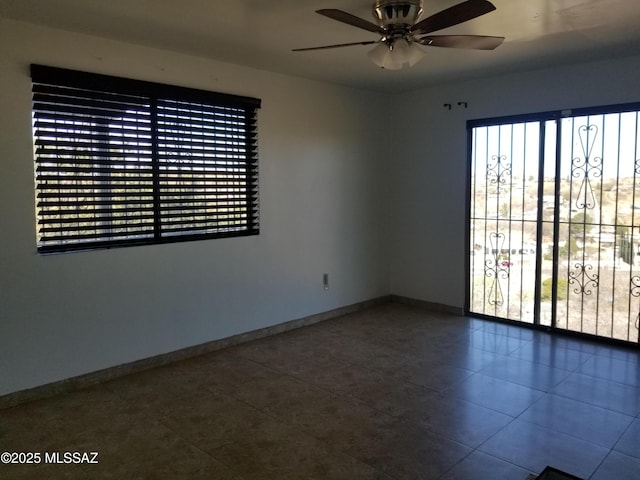 722 N Holm Cir, Nogales, AZ 85621 - empty room featuring ceiling fan, a wealth of natural light, and baseboards