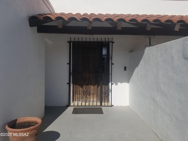 doorway to property featuring stucco siding