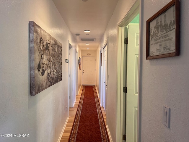 hall with hardwood / wood-style floors