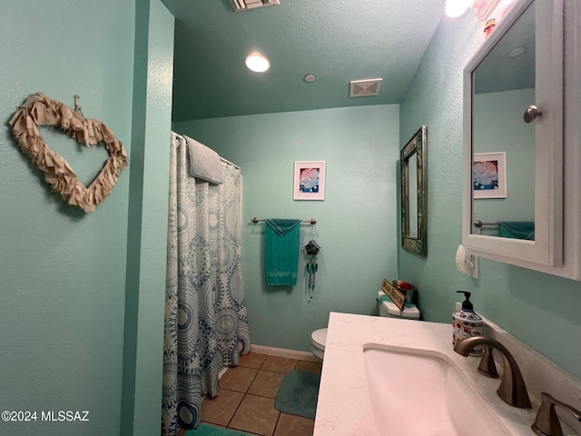 bathroom with tile patterned floors, a shower with curtain, vanity, a textured ceiling, and toilet