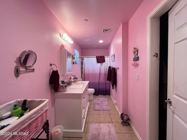 bathroom with tile patterned flooring, vanity, toilet, and a shower with curtain