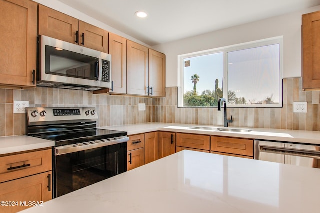 kitchen with stainless steel appliances, tasteful backsplash, and sink