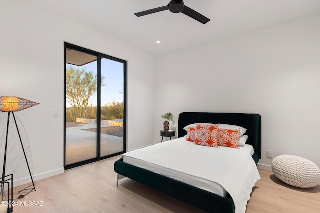 bedroom featuring access to outside, ceiling fan, and light wood-type flooring