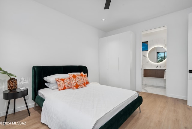 bedroom with ceiling fan and light wood-type flooring