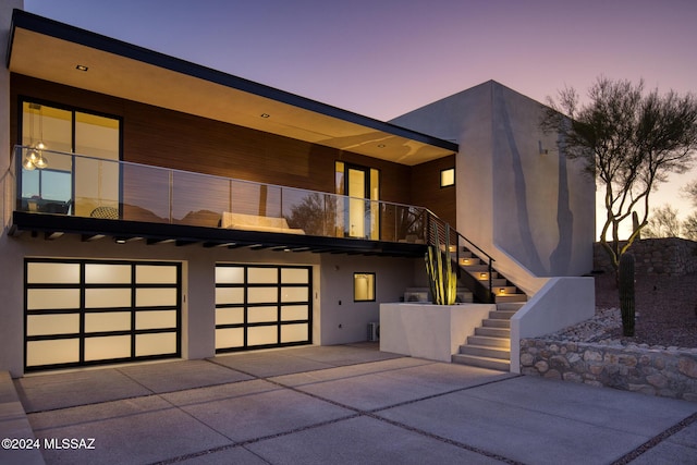 modern home featuring a garage and a balcony