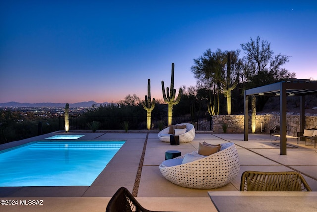 pool at dusk featuring a mountain view, a jacuzzi, and a patio