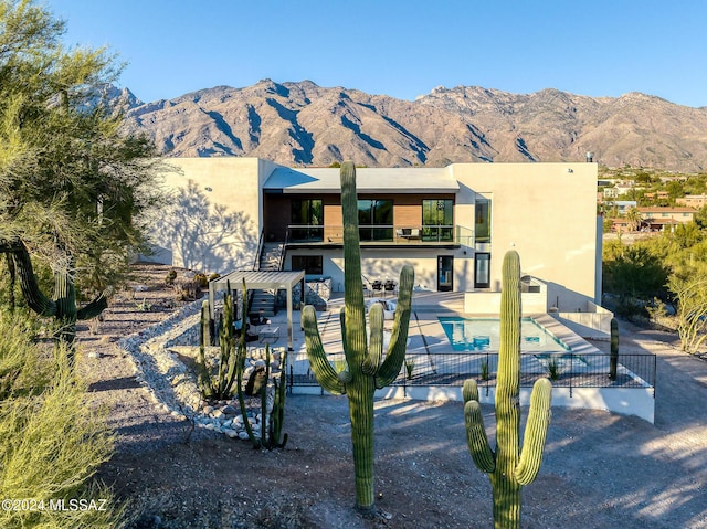 exterior space with a mountain view, a patio, and a balcony